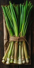 Fototapeta premium Vibrant Fresh Lemongrass Bundles Tied Together, Ready for Culinary Use in a Rustic Kitchen Setting.