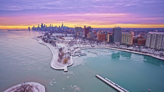 Cinematic drone shot over Chicago&rsquo;s Loop district in the winter dawn light.