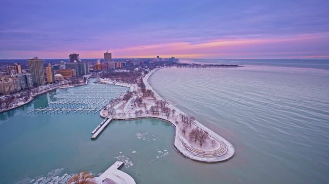 Cinematic drone view across the Chicago Loop at sunrise in winter.