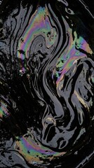 Fototapeta premium Swirling iridescent oil slick with rainbow reflections on black surface for abstract background and texture design