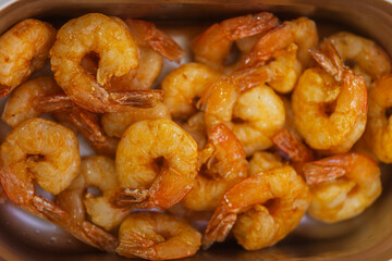 Fototapeta premium Golden Fried Shrimp In Bowl, Sizzling Garlic Butter Coating, Closeup Texture And Aroma, Chef Prep