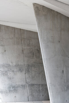 Abstract architecture detail of concrete column structure minimal modern geometric pattern texture under dramatic shadow for design background