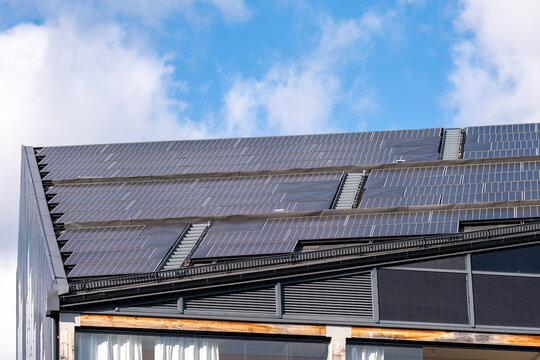 Solar panels across a modern rooftop in stockholm sweden highlight renewable energy technology and efficient building design for sustainability