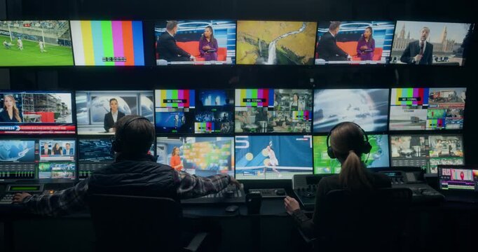 Backstage TV Station Production Control Room Shows Technicians Managing Live News Broadcasting, Switching Channel Feeds Monitoring. Entertainment, Weather, Sport, Reportage on Multiple Screens