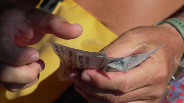 Hands counting money, man counting Russian ruble banknotes for financial transaction.