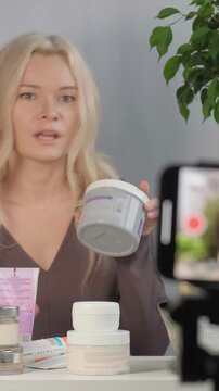 Woman Examining Cream Textures Closely. Inspecting Skincare Products With Careful Tactile Assessment. Intimate Scene Of Woman Carefully Testing And Inspecting Skincare Jars With Calm Demeanor