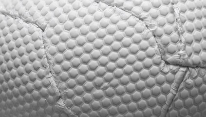 Fototapeta premium Showing honeycomb-quilted mattress cover revealing stitched seams and frayed thread in studio