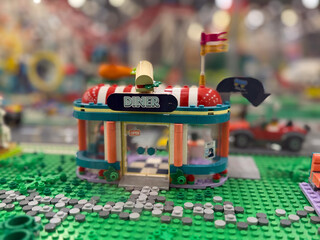 Fototapeta premium Colorful toy diner on green baseplate