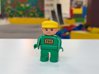 Fototapeta premium Green duplo zoo figure with yellow hat