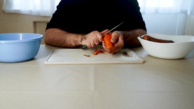 How to slice carrots for cooking in a simple kitchen setting