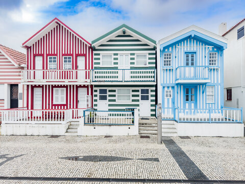 Colourful striped beach houses in Costa Nova do Prado, Aveiro, Portugal.