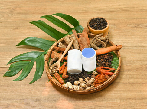 Thai herbal medicine ingredients menthol, camphor, borneol, clove and cinnamon in a wooden basket, aromatic natural herbs for inhaler and traditional wellness concept.&rdquo;