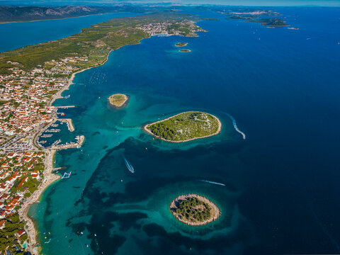 Aerial view of the picturesque coastline meets the azure sea, dotted with verdant islands and boats, Crvena Luka, Biograd na Moru, Zadarska zupanija, Croatia.