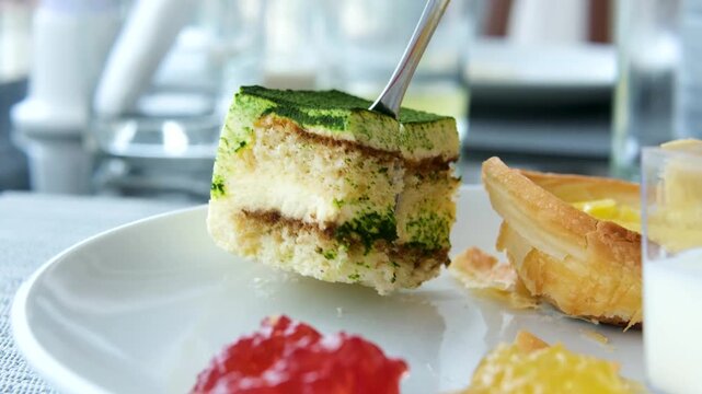 Yogurt portioned taken by the teaspoon desserts at the hotel breakfast buffet Portuguese pastries green cake jam.