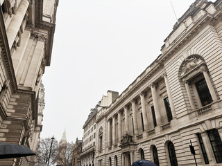 Naklejka premium Historic Institution of Civil Engineers government architecture on a cloudy street in London, UK with Elizabeth Tower