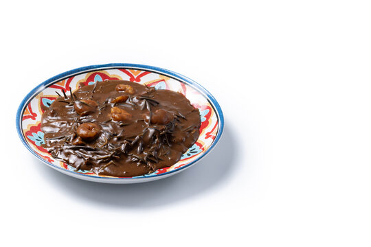 Mexican romeritos with mole sauce and shrimp isolated on white background. Copy space