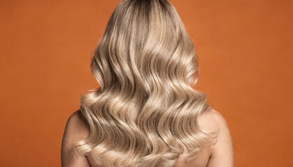 Fototapeta premium Woman back view, long wavy blonde hair, healthy beautiful curls vibrant