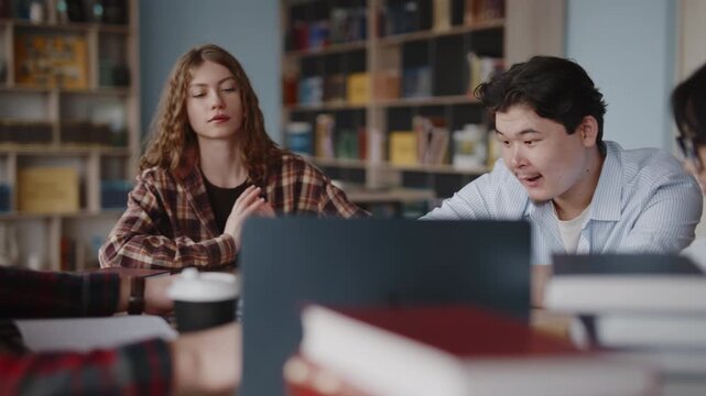 Diverse students collaborating on a project in a university library