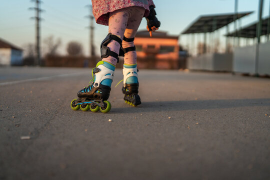Kid having fun rollerblading outdoors wearing protective gear