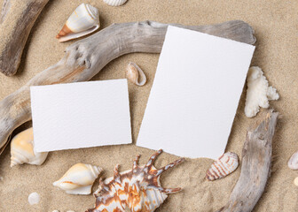 Wedding invitation card mockup set on sand with seashells and driftwood, beach event design © katrinshine