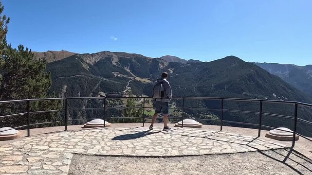 Boy looking at the mountain views from the Roc del Quer viewpoint in Andorra