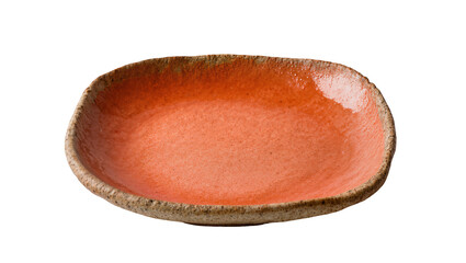 Rustic orange ceramic plate with an irregular, organic shape and textured rim, isolated on...