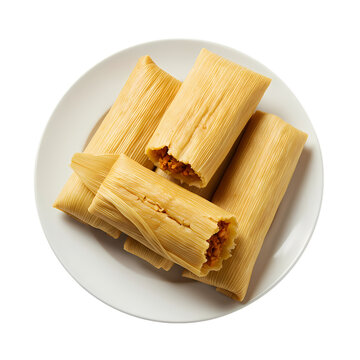 Freshly prepared corn husk tamales served on a clean white plate in this overhead studio photograph