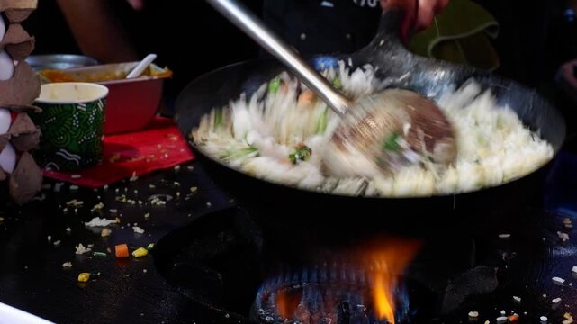 Popular Filipino street food consisting of fried rice, vegetables, and condiments sold on the streets.