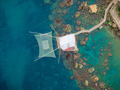 Aerial view of a trabucco stands as a testament to time, with its weathered wood contrasting against the turquoise sea, San Vito Chietino, Abruzzo, Italy.