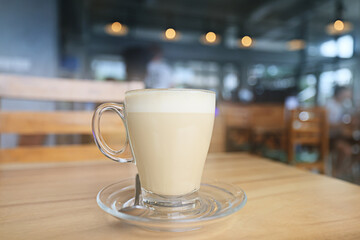Obraz premium cappuccino, coffee in a clear glass cup in a cafe, soft color background food and drink, hot drink
