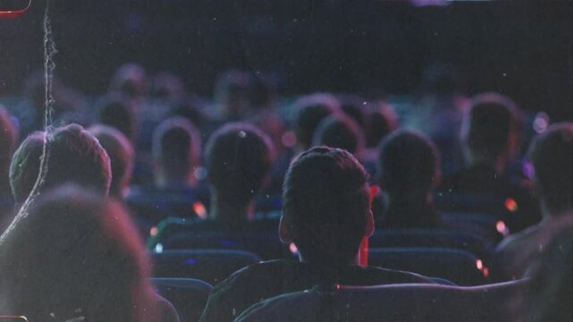 Crowd of spectators watching a show in a dark stadium