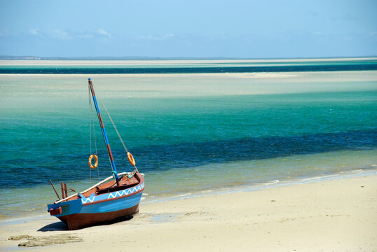 Traditional colourful dhow on a sandy beach at water's edge, Bazaruto island, Inhambane, Mozambique