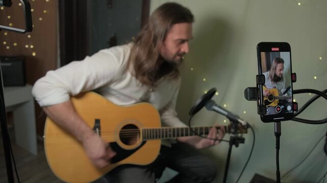 Home Musician Plays Intimate Acoustic Guitar. Indie Artist Singer Songwriter Shares Authentic Acoustic Music on Social Media. Guitarist Influencer Live Streaming And Inviting Live Performance Stream