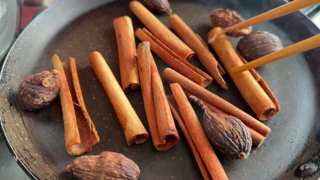 Aromatic whole spices stirred in cast iron pan, making Chettinad masala. High quality 4k footage
