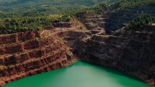 Bright green turquoise quarry lagoon aerial Evia Greece drone