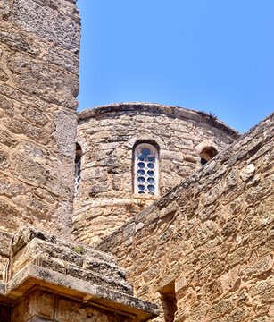 Close-Up of Ancient Stone Apse and Ornate Window of Saint Barnabas Church and Monastery, North Cyprus