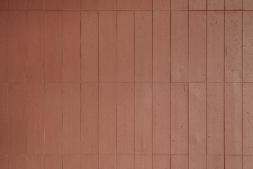 Vertical red terracotta tile wall texture. Modern architectural background with brick pattern and...