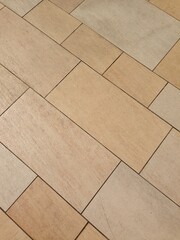 Fototapeta premium beige ceramic tiles arranged in rectangular pattern