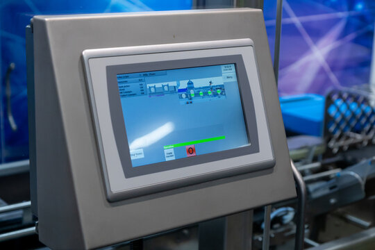 A close-up shot of an industrial control panel featuring an touchscreen display, showcasing the machine interface for a manufacturing process during an exhibition in Helsinki, Finland
