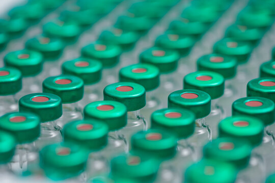 Closeup Rows Of Vaccine Vials With Green Caps, Sterile Tray Filling, Pharmacy Technician Preparing Doses, Cool