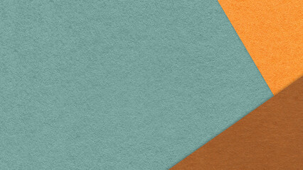 Fototapeta premium Muted teal textured paper background with orange brown triangular corners and copy space. Template for presentation, banner