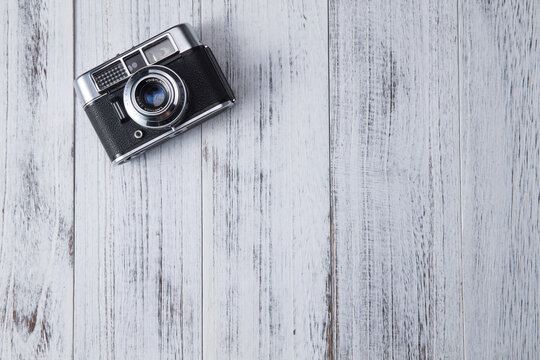 Vintage Rangefinder Camera on Whitewashed Wood Surface