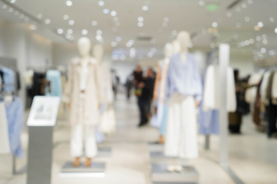 Abstract blur clothing boutique display interior of shopping mall background. blurred image background with clothing store.