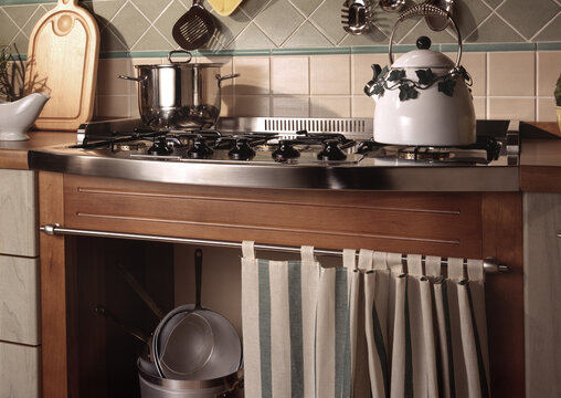 Close up of a kitchen cabinet with a steel hob