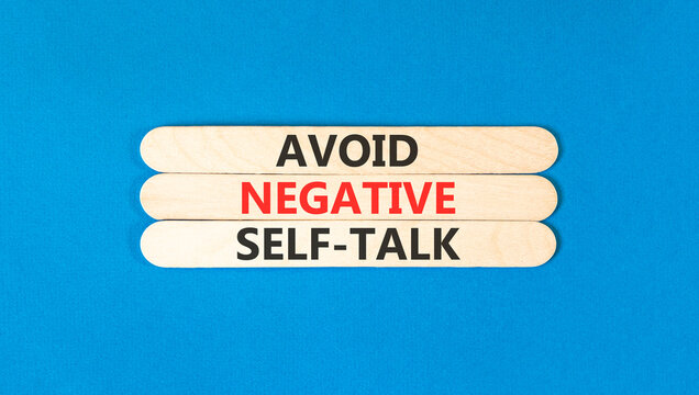 Avoid negative self-talk symbol. Concept words Avoid negative self-talk on beautiful wooden sticks. Beautiful blue background. Business psychology avoid negative self-talk concept. Copy space.