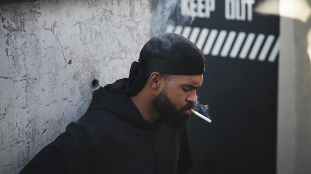 African American man in a durag smoking cigarette, harmful habits, urban scene