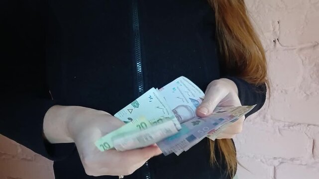 Stock video of a woman counting money Ukrainian hryvnias