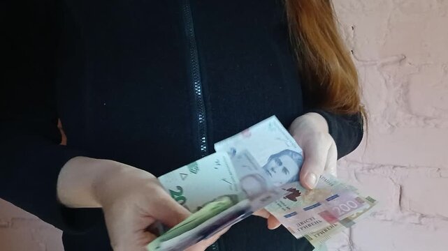 Stock video of a woman counting money Ukrainian hryvnias