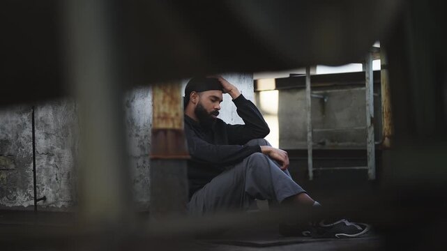 Unhappy African American man sitting on rooftop alone, suffering depression