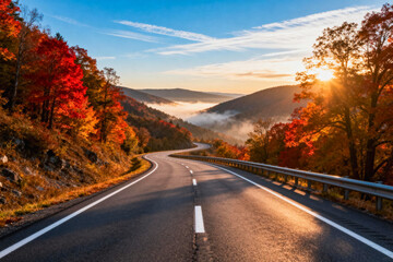 Fototapeta premium Scenic Autumn Road with Misty Valley and Sunset